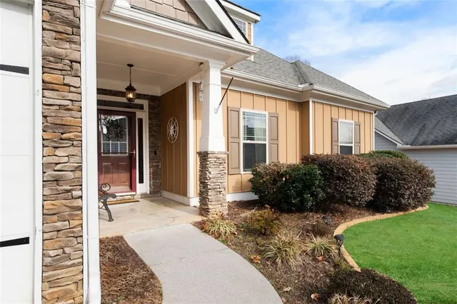 a view of a house with a yard and potted plants
