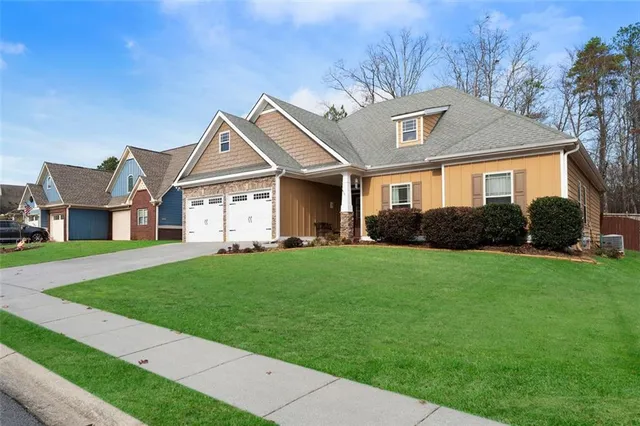 a front view of a house with a garden