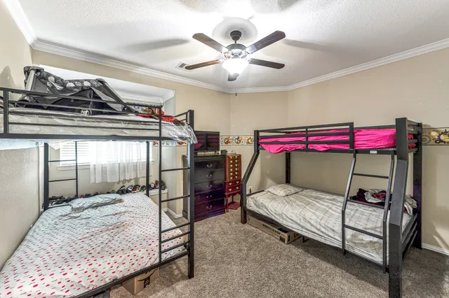 a bed room with a bed and a dresser