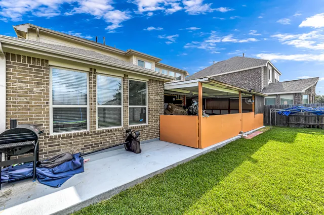 a view of a house with backyard porch and sitting area