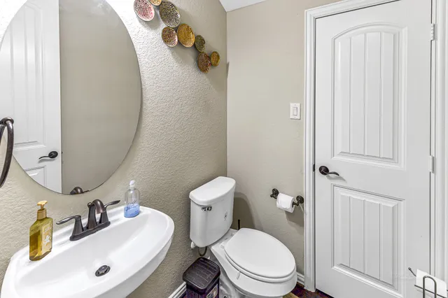 a white toilet sitting next to a bathroom sink