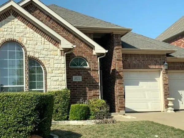 a view of a house with a door and a yard