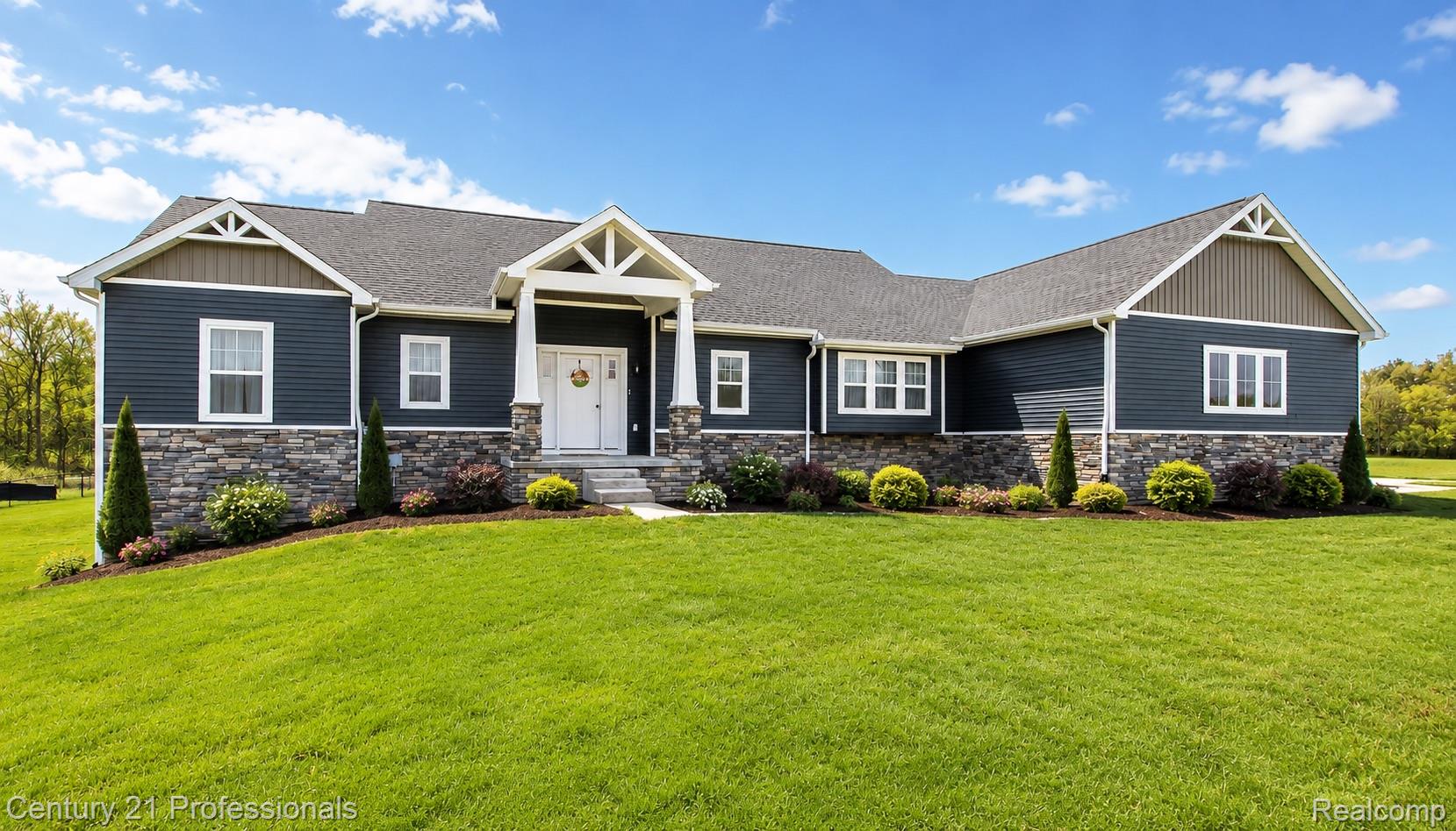 4914 TORATOLA Lane Howell, MI 48843 - Photo 1 of 39 Ranch-style exterior featuring dark blue siding, a stone facade, and white trim