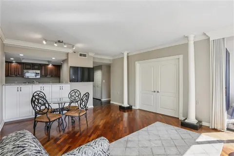 a kitchen with stainless steel appliances granite countertop a sink a stove a refrigerator cabinets and a counter top space