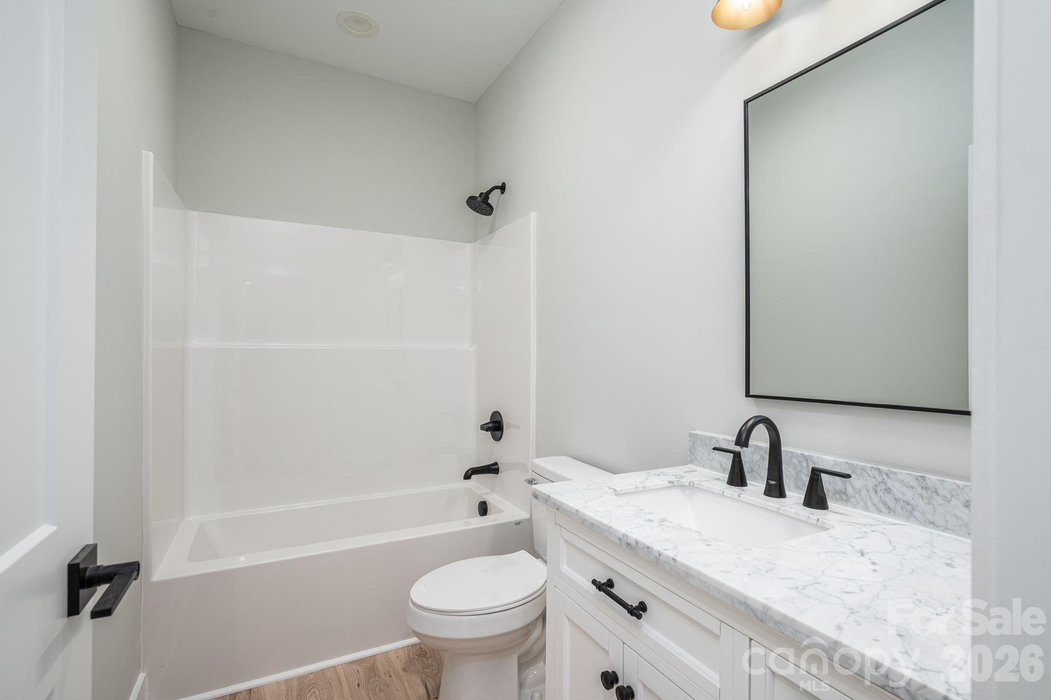 2474 Shoal Road Crouse, NC 28033 - Photo 30 of 39 a bathroom with a granite countertop sink a toilet and shower