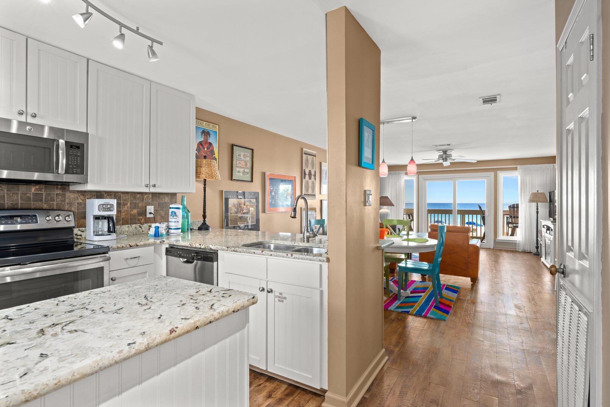 23011 Front Beach Road, Unit F7 Panama City Beach, FL 32413 - Photo 12 of 31 a view of a kitchen with dining table and chairs