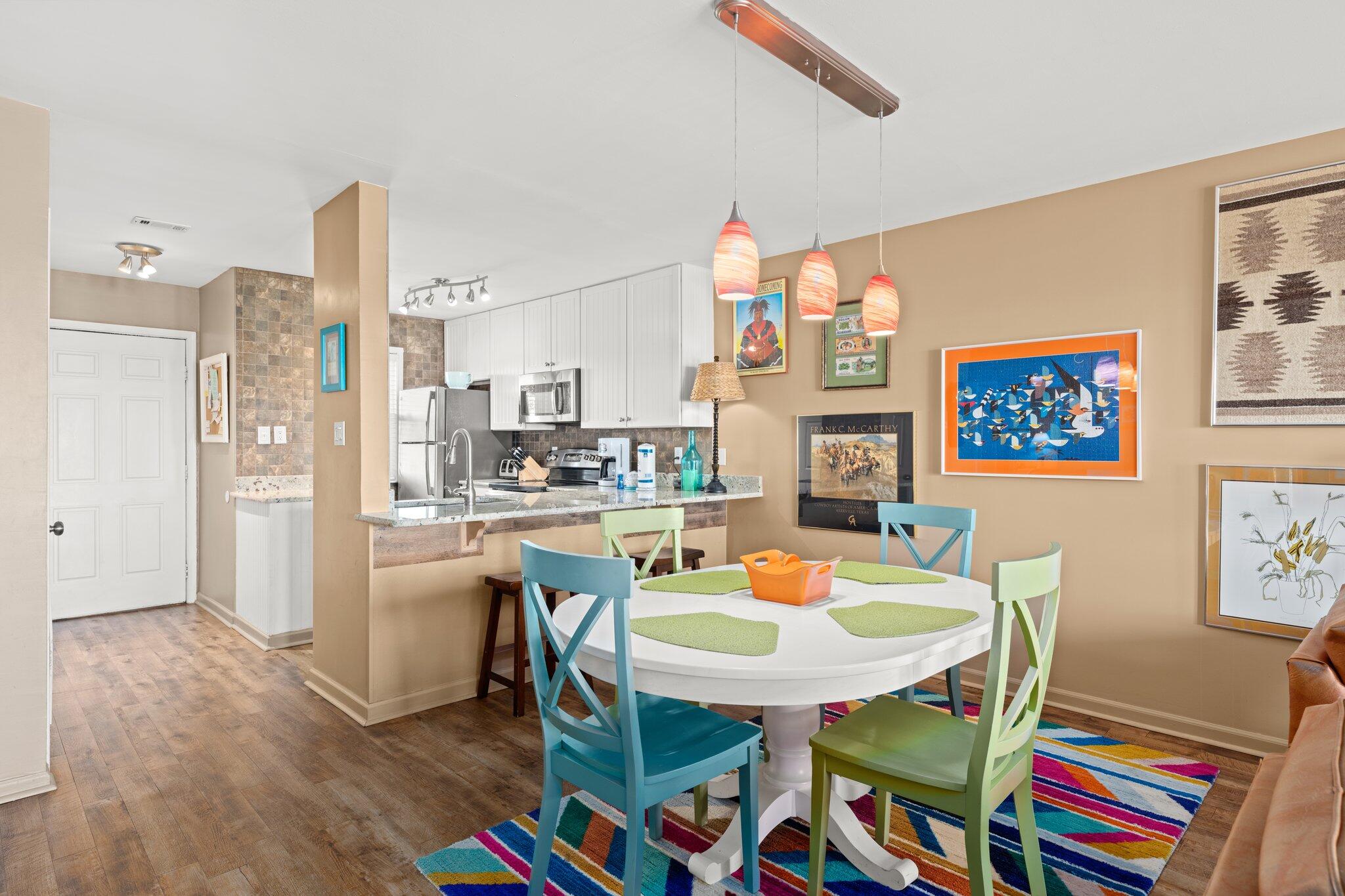 23011 Front Beach Road, Unit F7 Panama City Beach, FL 32413 - Photo 13 of 31 a dining room with furniture and wooden floor