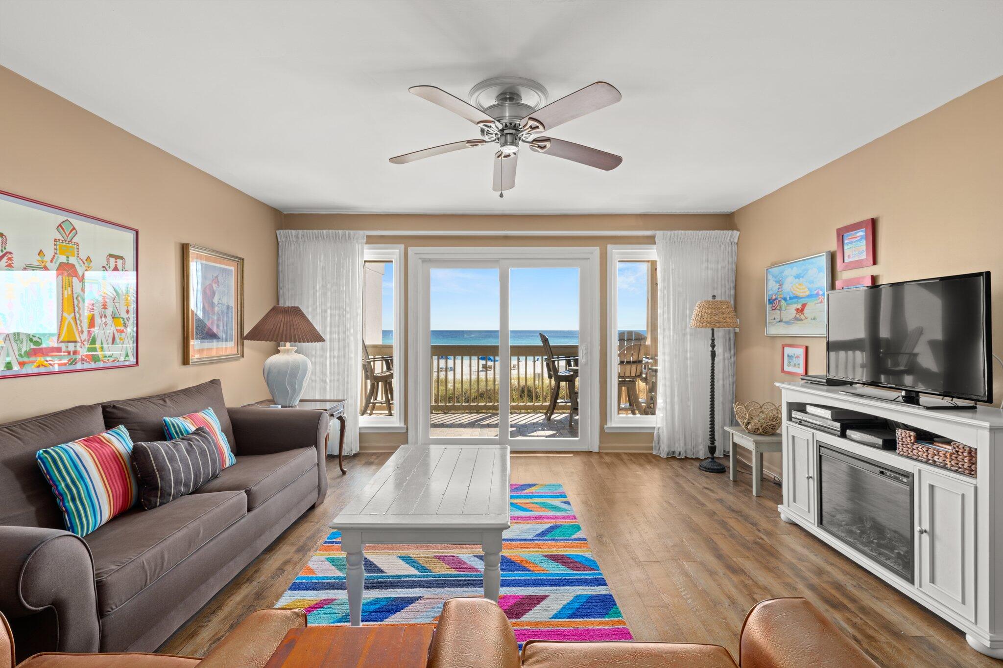 23011 Front Beach Road, Unit F7 Panama City Beach, FL 32413 - Photo 15 of 31 a living room with furniture and a flat screen tv