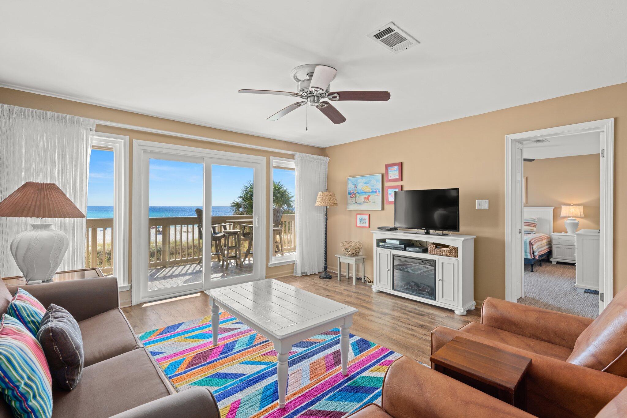 23011 Front Beach Road, Unit F7 Panama City Beach, FL 32413 - Photo 16 of 31 a living room with furniture and a flat screen tv