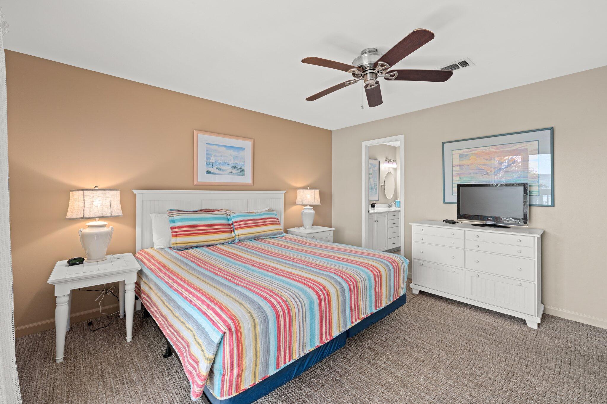 23011 Front Beach Road, Unit F7 Panama City Beach, FL 32413 - Photo 20 of 31 a bedroom with a bed and a flat screen tv