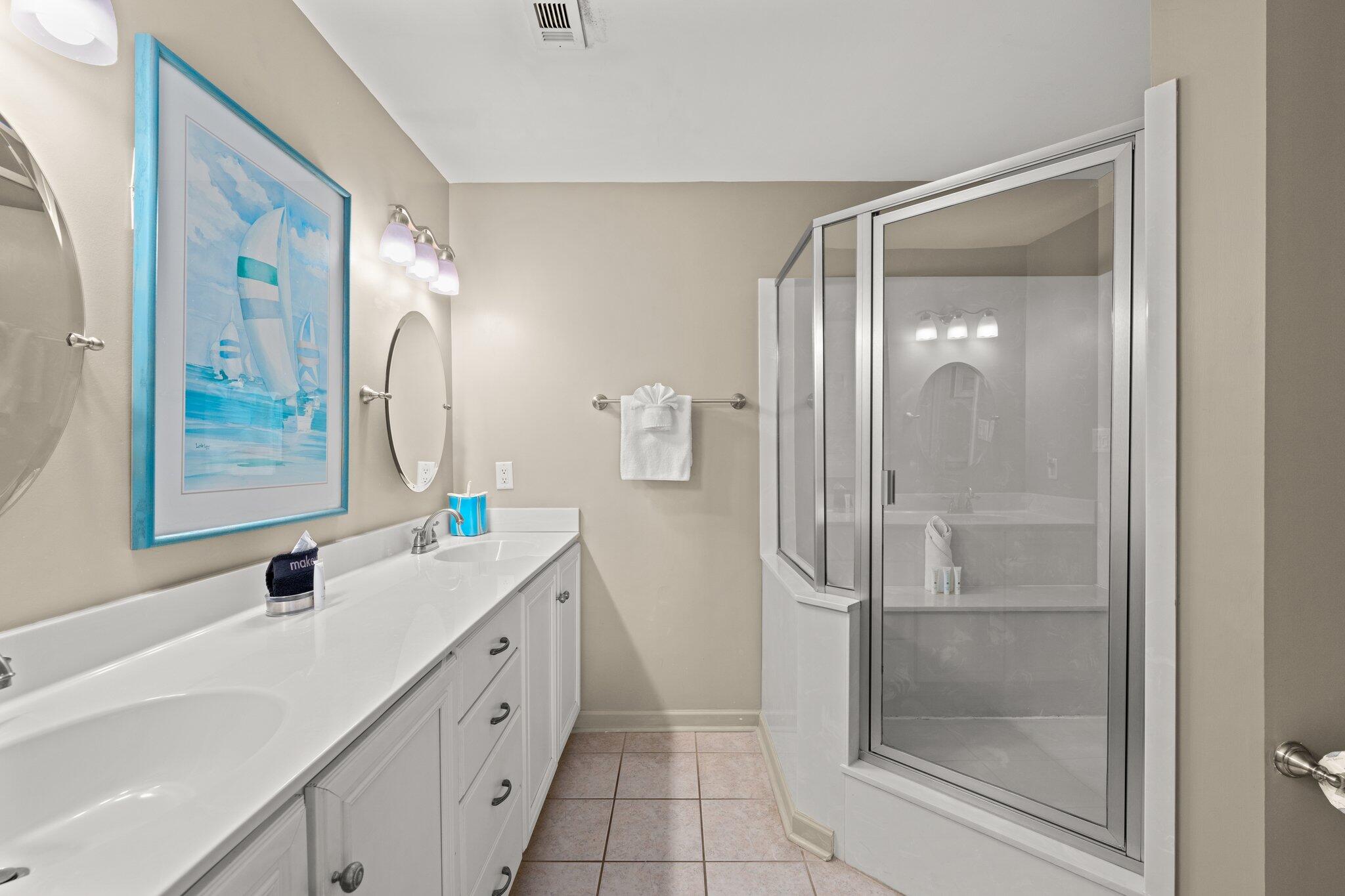 23011 Front Beach Road, Unit F7 Panama City Beach, FL 32413 - Photo 22 of 31 a bathroom with a double vanity sink a mirror and a shower
