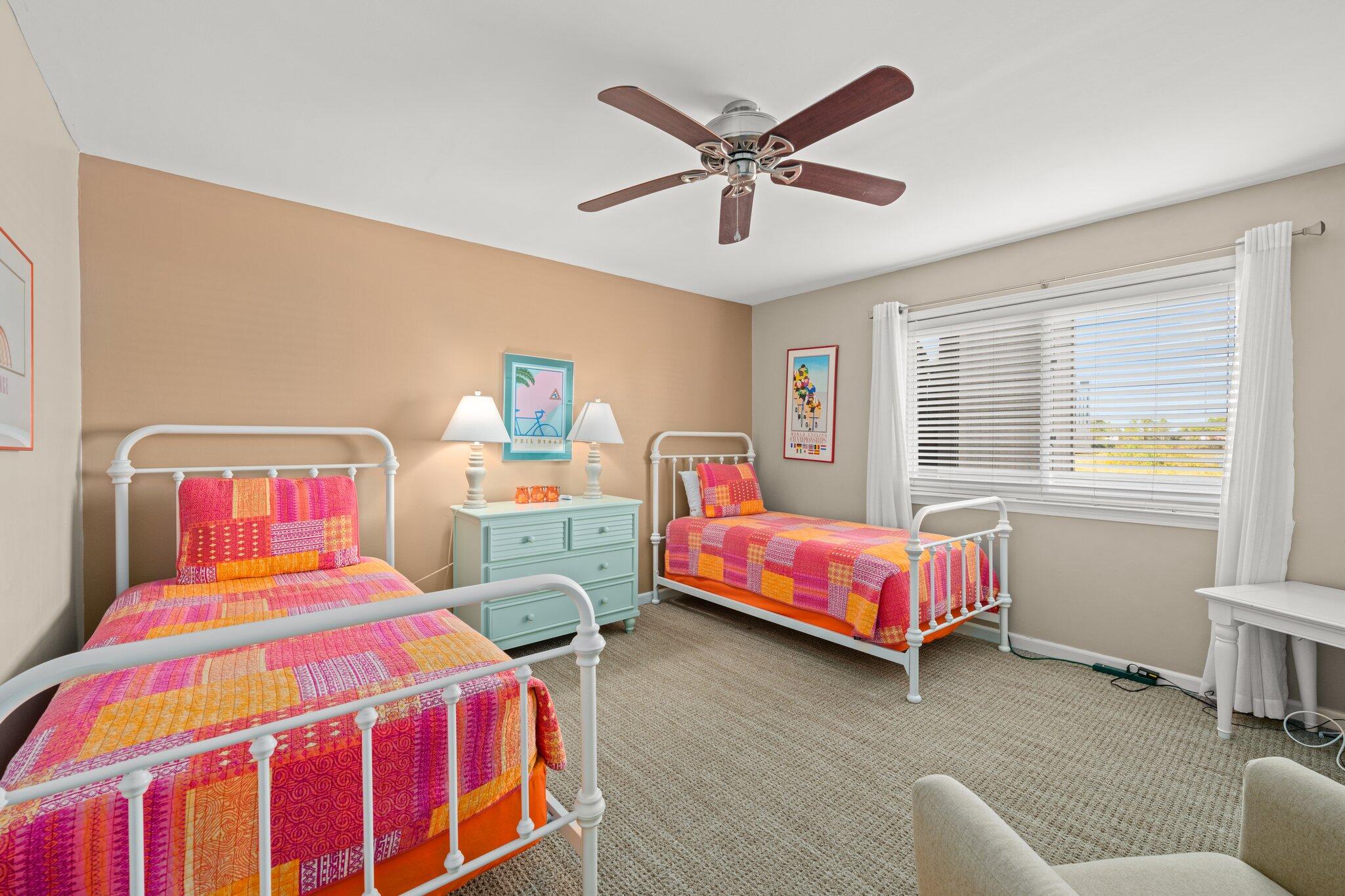 23011 Front Beach Road, Unit F7 Panama City Beach, FL 32413 - Photo 24 of 31 a bedroom with a bed a chandelier and dresser