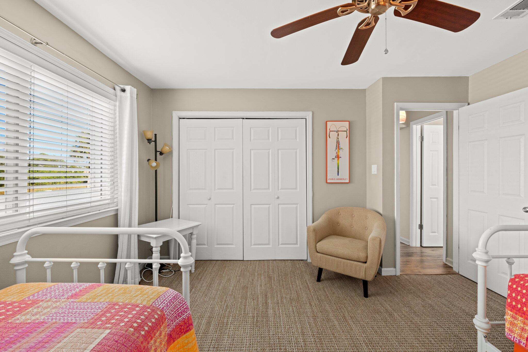 23011 Front Beach Road, Unit F7 Panama City Beach, FL 32413 - Photo 25 of 31 a bedroom with a bed and a chair