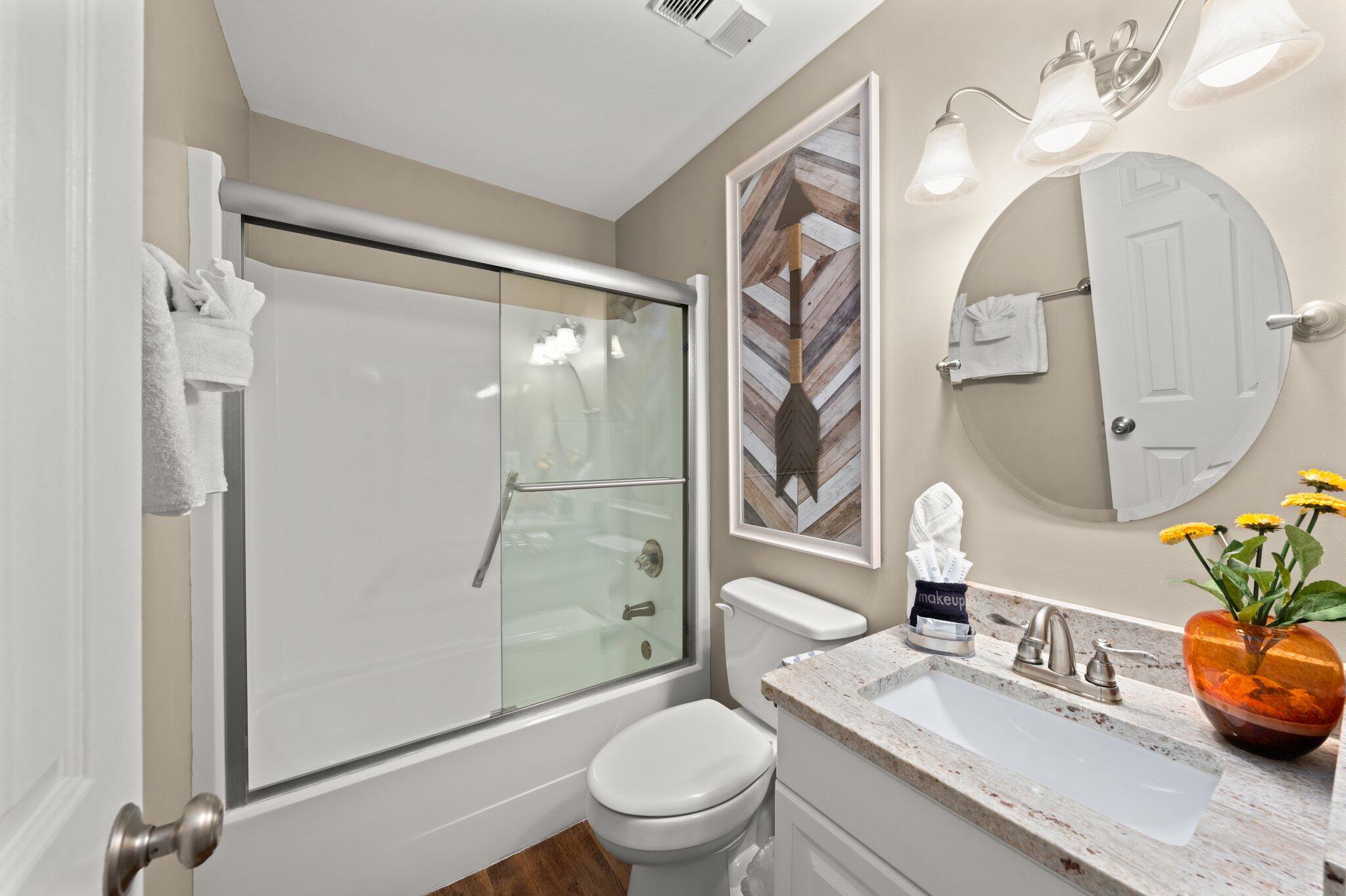 23011 Front Beach Road, Unit F7 Panama City Beach, FL 32413 - Photo 26 of 31 a bathroom with a sink a toilet and a large mirror