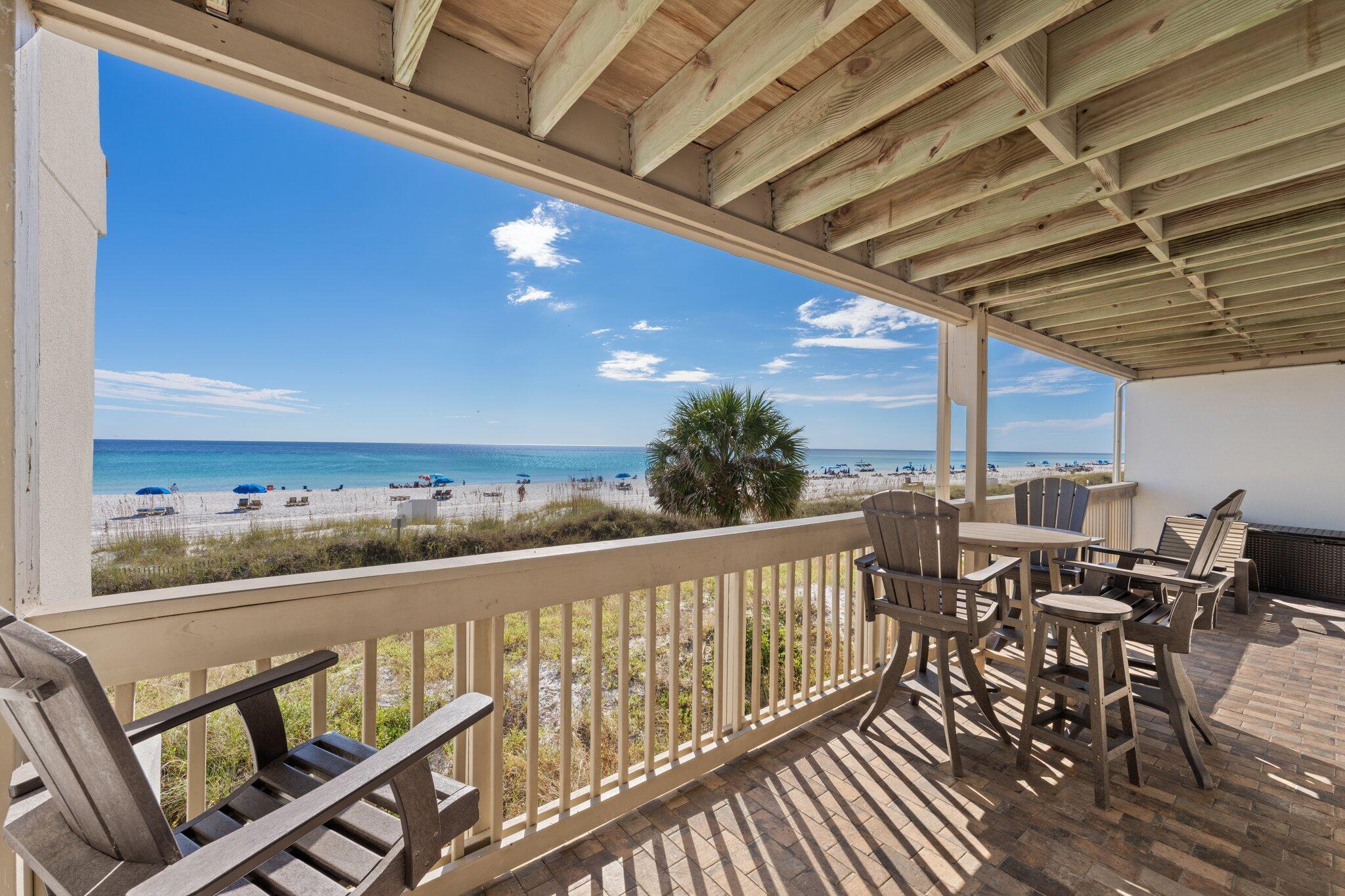 23011 Front Beach Road, Unit F7 Panama City Beach, FL 32413 - Photo 6 of 31 a view of a balcony with chairs and wooden floor