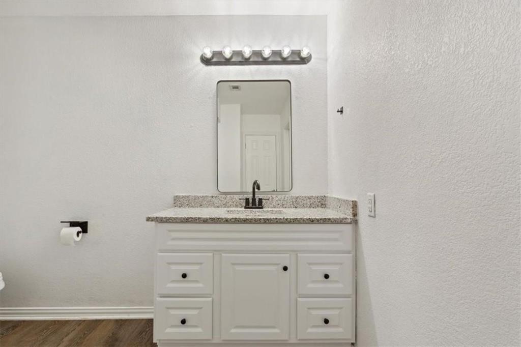 2306 Melissa Drive Waco, TX 76708 - Photo 15 of 22 a bathroom with a granite countertop sink and a mirror
