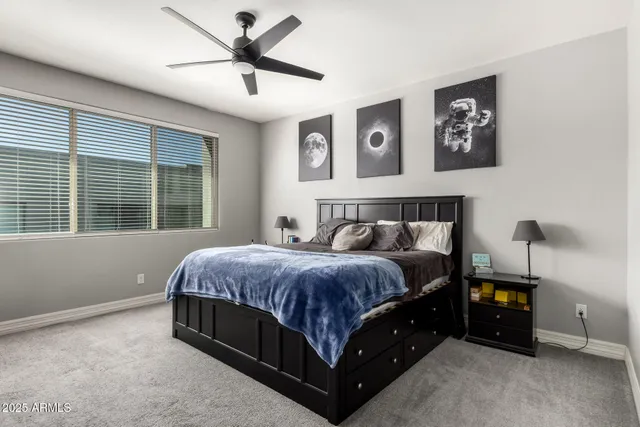 a spacious bedroom with a bed and window