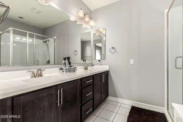 a bathroom with a double vanity sink and a mirror