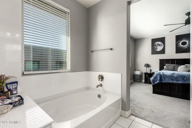 a bathroom with a bathtub and a window