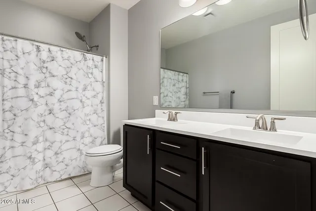 a bathroom with a sink toilet and mirror