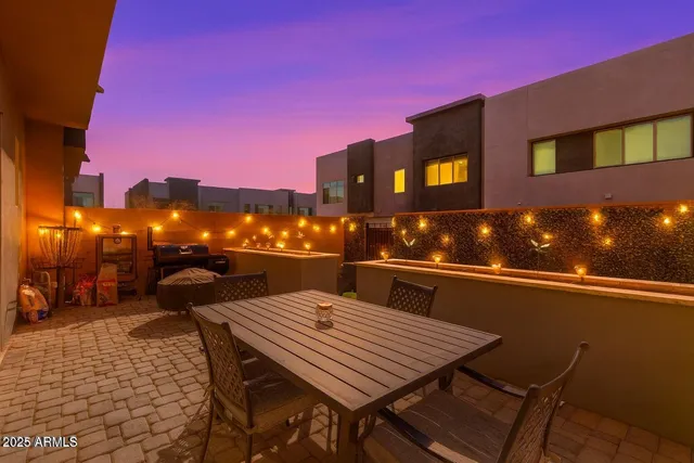 a terrace of a house with table and chairs