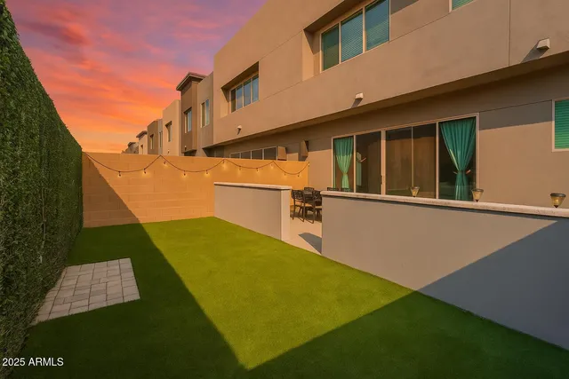 a view of a backyard with chairs