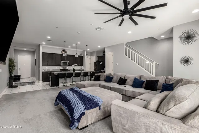 a living room with furniture and kitchen view