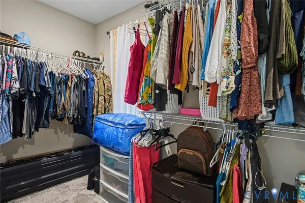 a bedroom with a bed and a chandelier fan