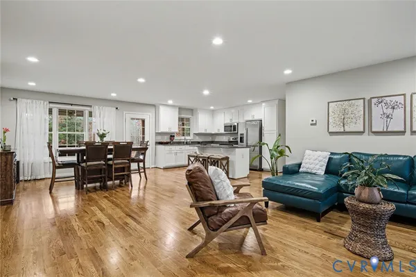 a living room with furniture and kitchen view