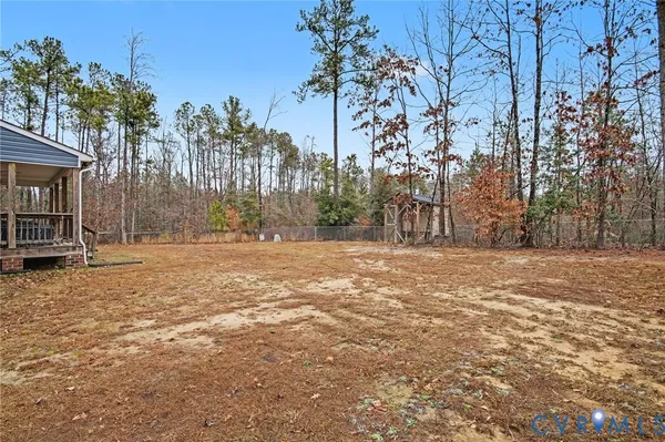 a view of a yard in front of a house with large tree