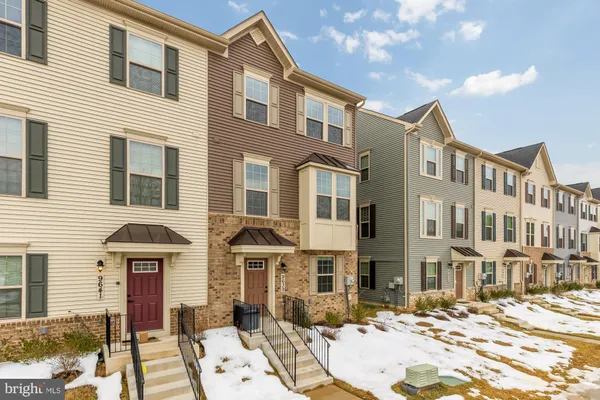 a front view of a residential apartment building with a yard