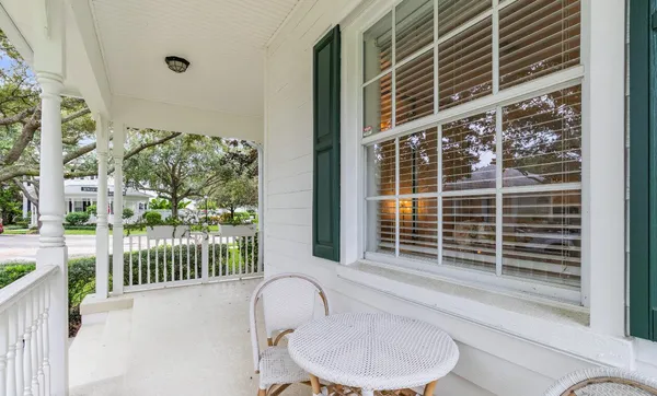 a balcony with table and chairs