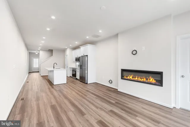 a view of a kitchen with a sink and a refrigerator