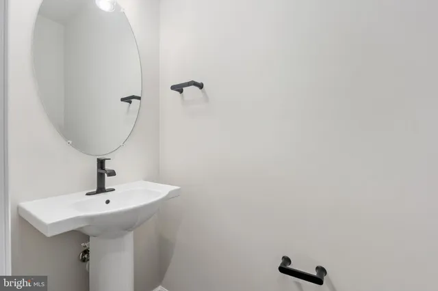 a bathroom with a sink and mirror