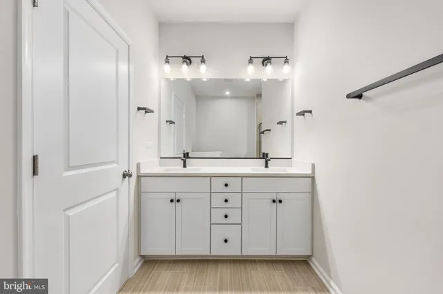 a bathroom with a double vanity sink and mirror