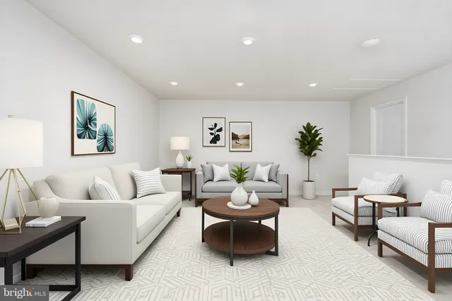 a living room with furniture and painting on the wall