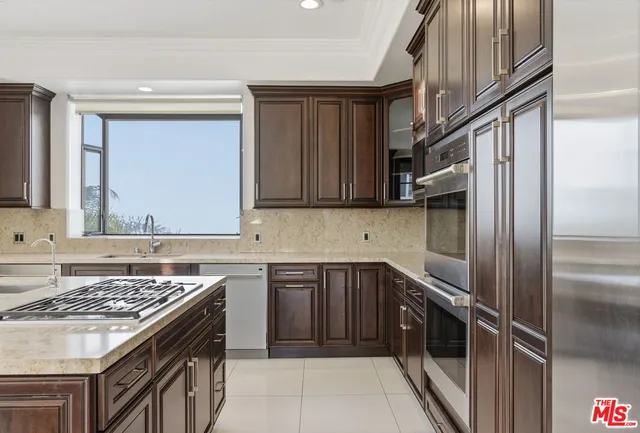 a kitchen with a sink stove and cabinets