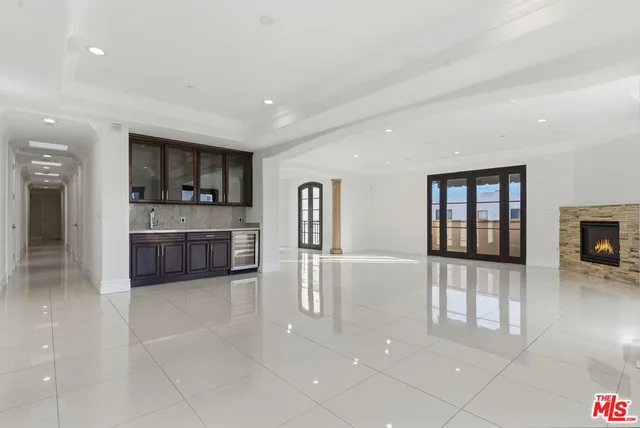 a large living room with stainless steel appliances granite countertop a couch and a view of living room