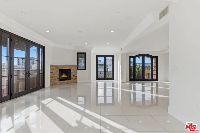 a view of a livingroom with a fireplace and window