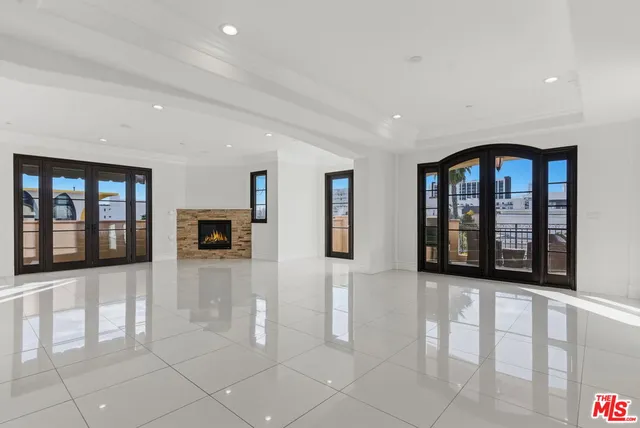 a view of a big room with windows and entryway