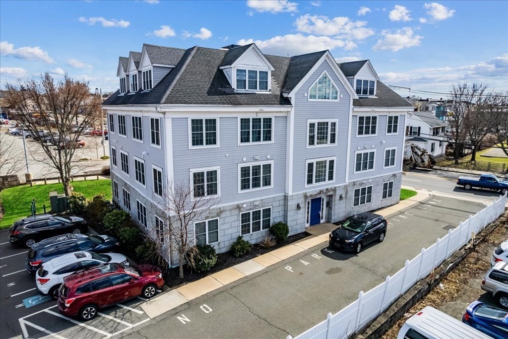 a front view of a residential apartment building with a yard