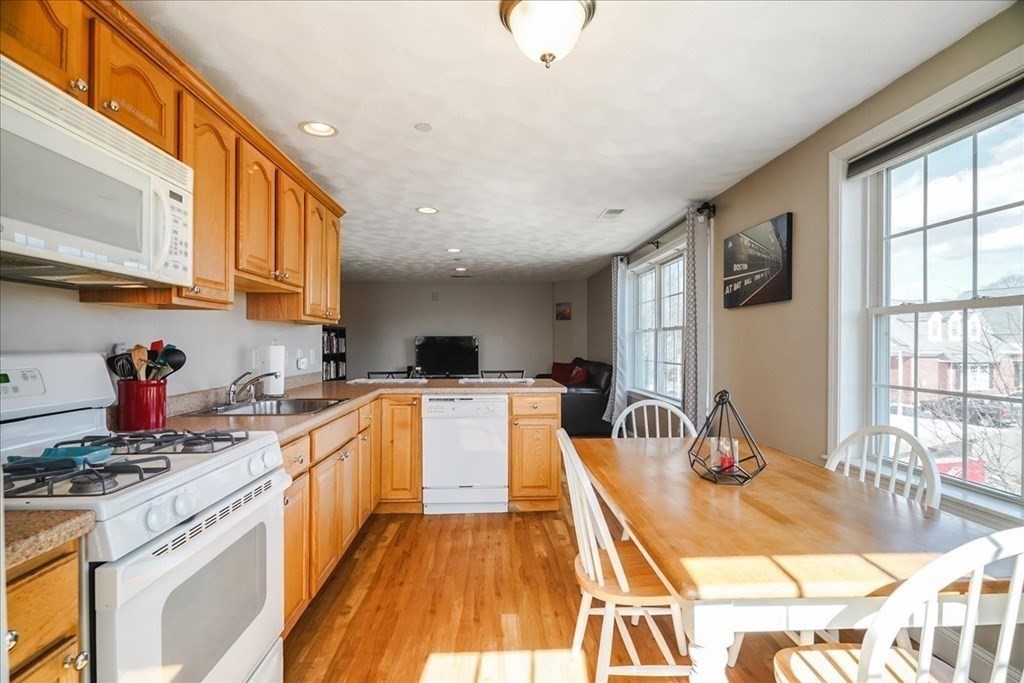 103 Elliott Street, Unit 12 Beverly, MA 01915 - Photo 12 of 25 a kitchen with stainless steel appliances granite countertop a sink and cabinets