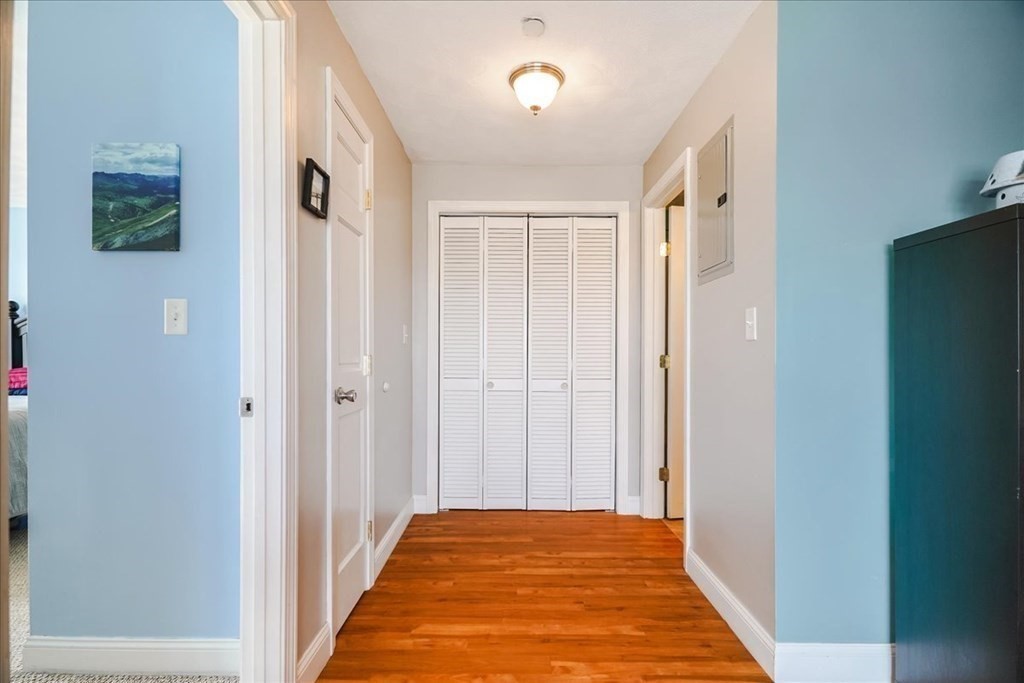 103 Elliott Street, Unit 12 Beverly, MA 01915 - Photo 15 of 25 a view of a hallway with wooden floor and a bathroom