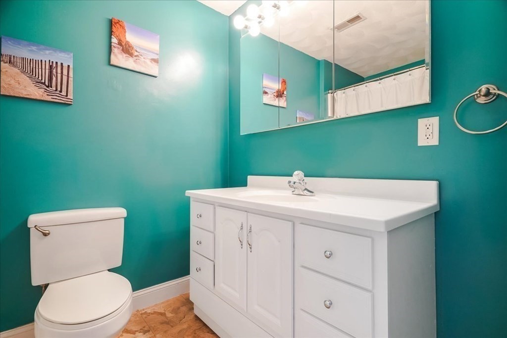 103 Elliott Street, Unit 12 Beverly, MA 01915 - Photo 20 of 25 a bathroom with a sink mirror and toilet