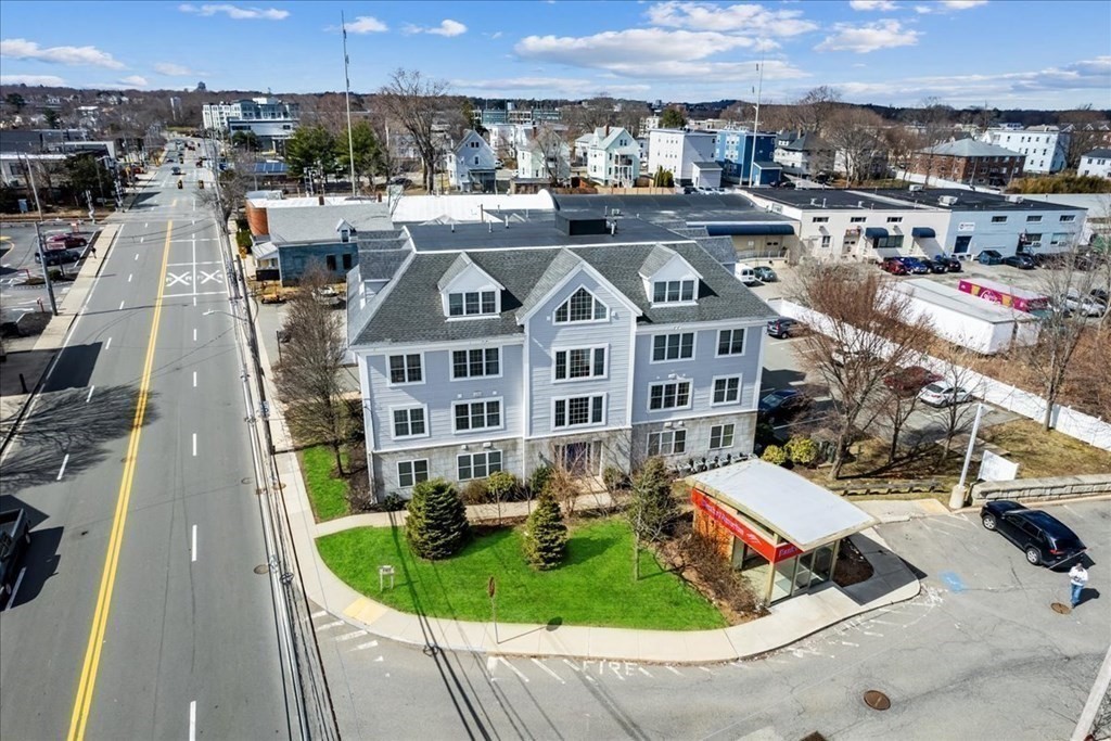103 Elliott Street, Unit 12 Beverly, MA 01915 - Photo 2 of 25 a aerial view of a house with a yard