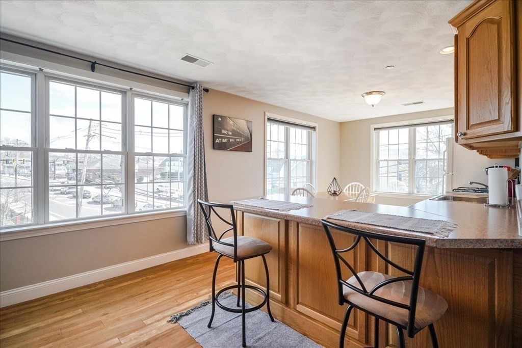 103 Elliott Street, Unit 12 Beverly, MA 01915 - Photo 9 of 25 a view of a dining room with furniture window and wooden floor