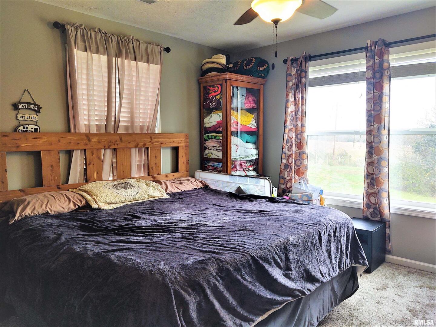 1470 Old Bloomfield Road Vienna, IL 62995 - Photo 12 of 25 a bedroom with a bed and a chandelier next to a window