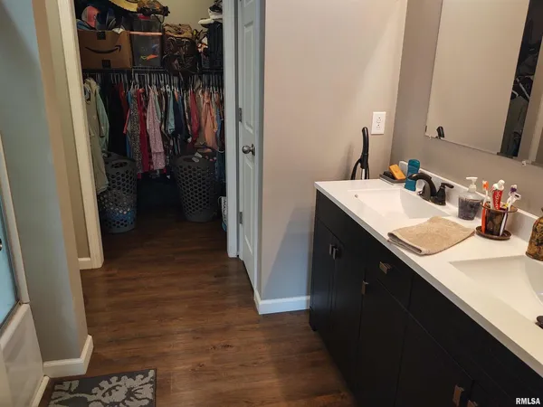 a bathroom with a sink a mirror and shower
