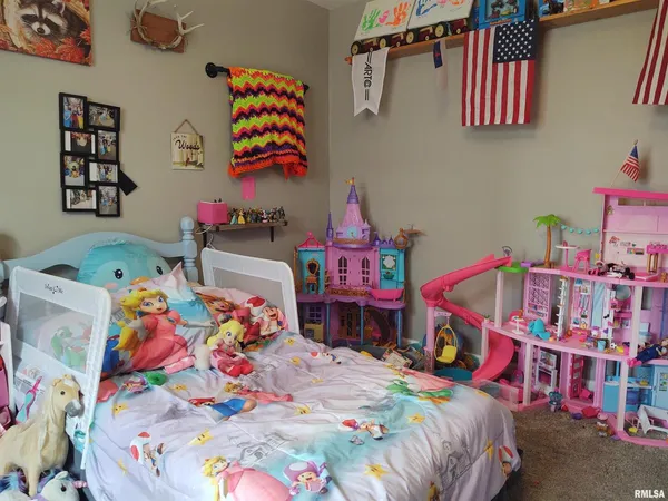 a kids bedroom with a bed a baby crib and a baby crib