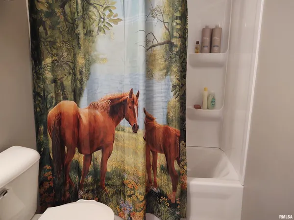 a bathroom with a toilet and shower
